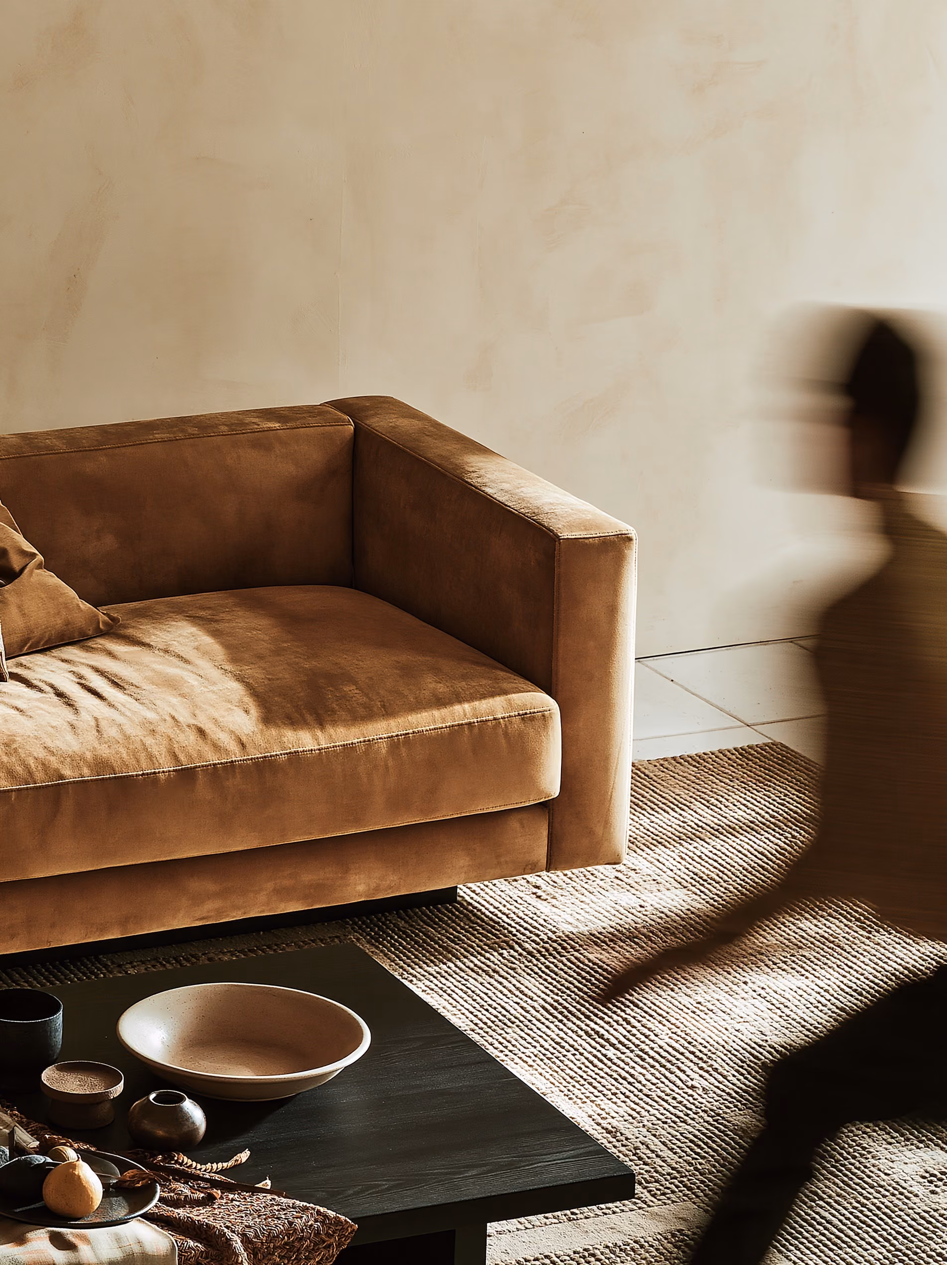 Composed editorial living room with camel velvet sofa and plaster walls — considered, deliberate space that reinforces designer authority when presenting an AI render to a client.